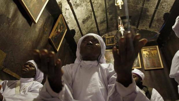 Peregrinos nigerianos rezan en la gruta de la Iglesia de la Natividad, en Belén